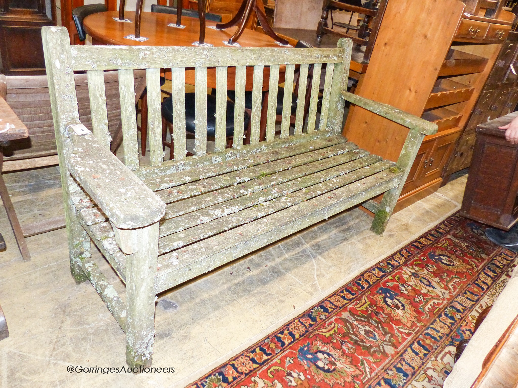 A weathered teak garden bench, length 160cm, depth 56cm, height 90cm